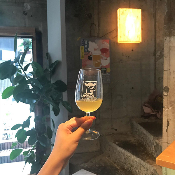 渋谷にあるデンマーク発のビアバー「Mikkeller Tokyo」の、イラスト入りグラスに注がれたクラフトビール