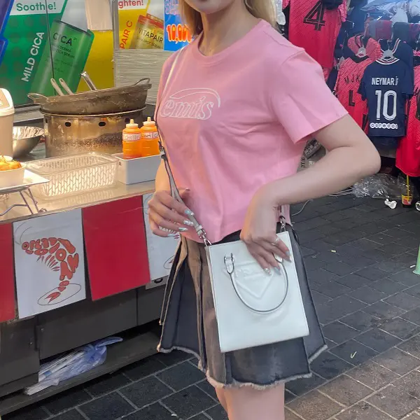 韓国のファッションブランド「emis（イミス）」のロゴTシャツを着ている女性